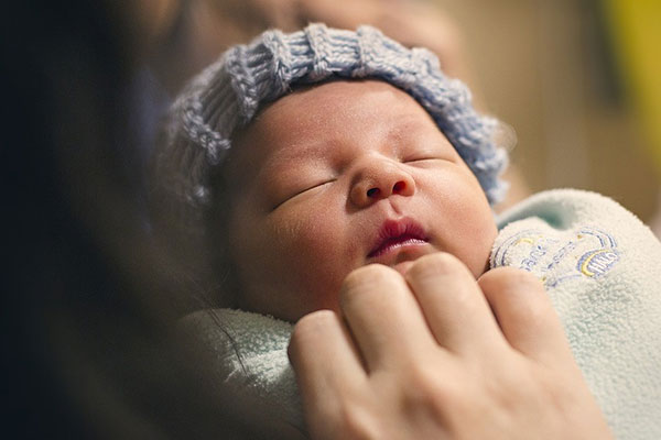 Caregiver looking after an infant baby