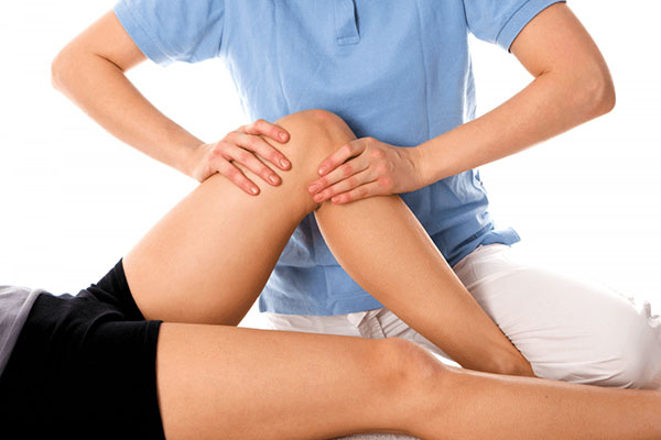 Physiotherapist assisting patient with rehabilitation